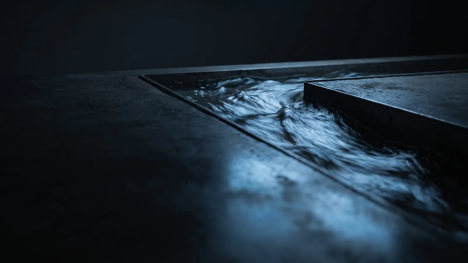 Fast-moving water in a dark channel with blue reflections.